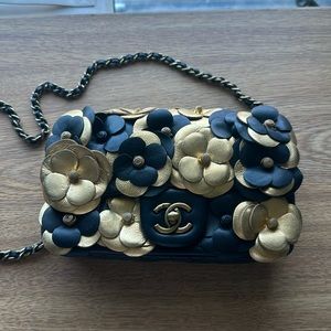 This is a lovely cocktail purse, pure leather, black and gold by Chanel